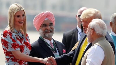 U.S. President Donald Trump greets U.S. White House senior advisor Ivanka Trump next to Indian Prime Minister Narendra Modi as they arrive at Sardar Vallabhbhai Patel International Airport in Ahmedabad. REUTERS