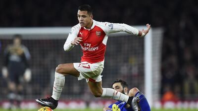 Arsenal’s Alexis Sanchez dribbles past Chelsea’s Cesc Fabregas on Sunday during their Premier League contest. Dylan Martinez / Reuters
