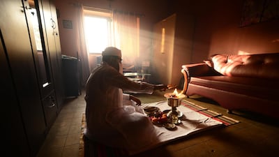 In Karachi, priest Berjise Bhada prepares a fire to begin the Jashan thanksgiving ceremony, practiced by those of the Zoroastrian faith. The fire is considered holy, and priests must cover their noses and mouths to prevent their breath from contaminating it. Mobeen Ansari
