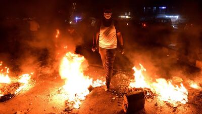 Iraqi protesters set fire to block a street during a strike and anti-government demonstrations at the Al-Tayaran Square in central Baghdad. EPA