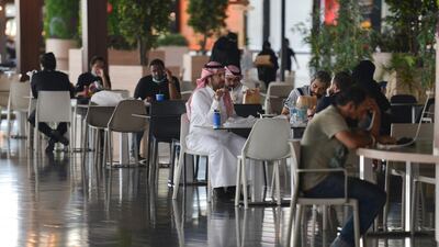 People sit at a cafe in a mall in Riyadh. AFP