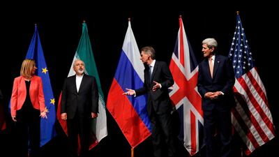 Then British Foreign Secretary Philip Hammond gestures towards Iranian Foreign Minister Mohammad Javad Zarif as then US Secretary of State John Kerry and European Union High Representative for Foreign Affairs and Security Policy Federica Mogherini looked on after reaching a nuclear deal in 2015. AFP, pool, FILE .