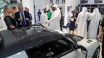 Visitors discuss the cars.