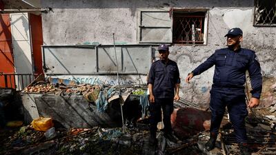 Palestinian police officers inspect damage in Gaza after the latest bout of fighting. Reuters