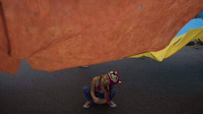 A girl plays under a giant flag during a protest against the Brazil’s president Michel Temer at Copacabana beach in Rio de Janeiro. Leo Correa / AP Photo
