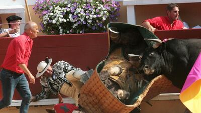 A picador and his horse fall as a bull charges during the Atlantique corrida in Bayonne. AFP