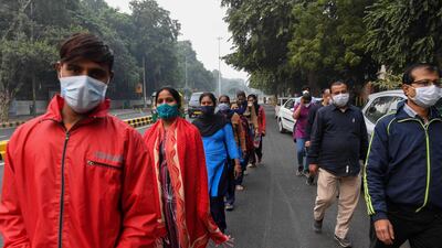 People wearing facemasks participate in a walkathon organised by Ram Manohar Lohia hospital to raise awareness on the Covid-19 coronavirus, in New Delhi. AFP