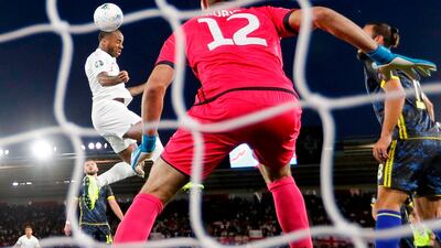 England midfielder Raheem Sterling heads the ball to score his team's first goal. AFP