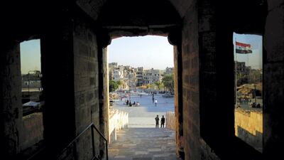 Syrian soldiers stand guard at the main gate of the ancient Citadel in the old city of Aleppo, Syria. AP