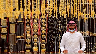 A merchant displays gold jewellery at his shop in Dubai Gold Souq in the Gulf emirate on July 29, 2020. (Photo by GIUSEPPE CACACE / AFP)