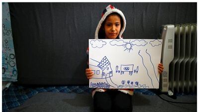 Syrian refugee Hale Selim, 13, as she shows her drawing of her home in Syria, in her tent in Yayladagi refugee camp in Hatay province near the Turkish-Syrian border, Turkey.