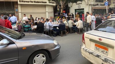 The rush before iftar as volunteers put bread and rice out on the tables