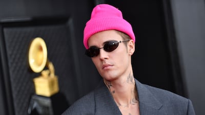 Justin Bieber wore an oversized grey suit by Balenciaga, accessorised with a hot pink beanie. AFP