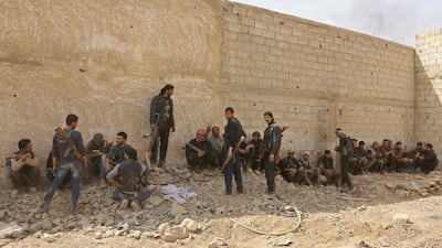 Syrian rebel fighters hand themselves over to government troops on March 23, 2018 as regime forces move in to the outskirts of Ain Tarma, in the south of the Eastern Ghouta region outside Damascus, after a deal was reached with a rebel group that controlled the area. AFP