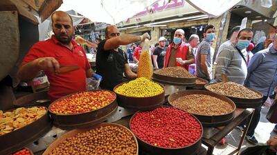 Shoppers and stallholders at a busy market ahead of Ramadan in Amman. AFP