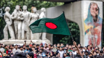 A student waves Bangladesh's national flag, during a protest to demand accountability and trial against the country's ousted Prime Minister Sheikh Hasina, near Dhaka University in the capital on August 12. AFP