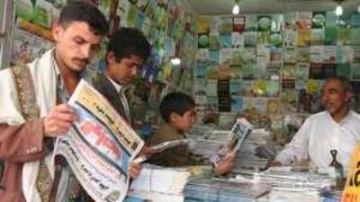 Yemenis flip through newspapers at a shop in Sana'a.