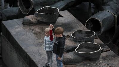 Children depict a Soviet monument to friendship between Ukrainian and Russian nations after its demolition, amid Russia's invasion of Ukraine, in central Kyiv. Reuters