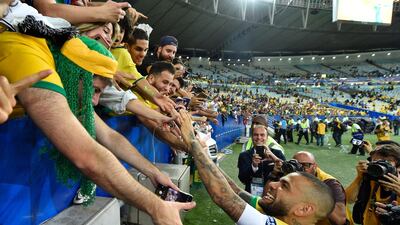 Dani Alves celebrates with fans. Getty