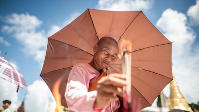 A Buddhist devotee lights incense at the Shwedagon Pagoda to mark the full moon day of the Thadingyut festival in Yangon, Myanmar. AFP