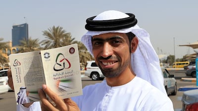 Abdulla Al Kaabi, one of the authors showing his first edition of the “Emirati Ramsa” dictionary which provides the translation of about 1,500 Emirati words into English. Ravindranath K / The National