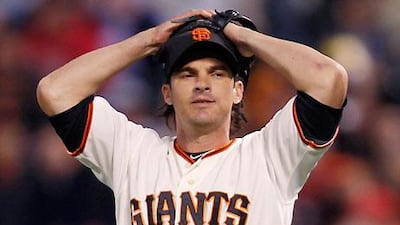 San Francisco Giants' second baseman Ryan Theriot shows the strain against Washington