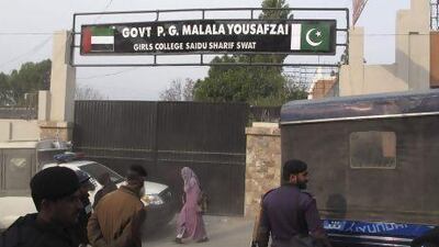 Police officers stand guard after students protest against the naming of Saidu Sharif College after schoolgirl Malala Yousufzai, in the Swat Valley.