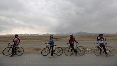 Malika Yousufi, right, Masooma Alizada, second right, Frozan Rasooli, third right, and Zahra Alizada, left, members of Afghanistan’s Women’s National Cycling Team take a break from training. Mohammad Ismail / Reuters