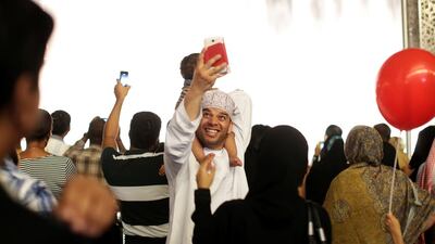 Dubai residents take pictures by Dubai Mall. Christopher Pike/ The National