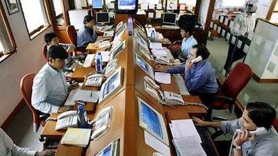 Stockbrokers trade in Mumbai. Many Indian-born executives are returning home, trading their dream of conquering Wall Street or Silicon Valley for working in Gurgaon or Mumbai. Reuters