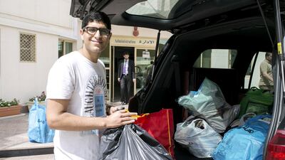 Dubai American Academy pupil Ali Hassani with some of the titles collected in a book drive he organised to help stock the new library at Al Arqam Private School in Al Barsha. The books will benefit about 1,000 pupils who attend the school. Reem Mohammed / The National