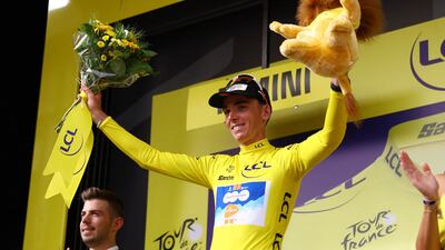 Romain Bardet celebrates on the podium wearing the yellow jersey after winning Stage 1 of the Tour de France on Saturday, June 29, 2024. Reuters
