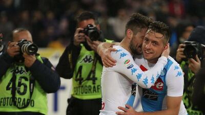 Napoli's midfielder Emanuele Giaccherini, right, celebrates embracing his teammate Dries Martens after scoring a goal during the Italian Serie A soccer match against Genoa at the San Paolo in Naples, Italy, Friday, February 10 2017. Cesare Abbate / AP Photo
