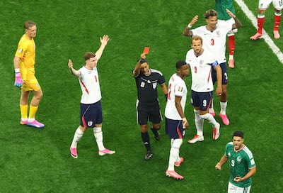 Referee Alireza Faghani shows a red card to England's Jarell Quansah. Reuters