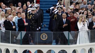 US President Donald Trump and Vice President Mike Pence, far left, at Mr Trump's inauguration ceremony in 2017, an event that was attended by former president Barack Obama and his wife Michelle. AP
