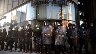 Lebanese riot police guard a bank in the capital Beirut. AFP
