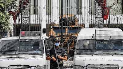 A member of Tunisia's security forces stands guard outside parliament headquarters in Bardo in Tunis on July 31, 2021. AFP