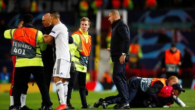 Juventus' Cristiano Ronaldo looks on as stewards apprehend pitch invaders after the match. Reuters