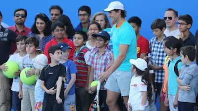 Rafael Nadal poses with fans at Zayed Sports City in Abu Dhabi on Thursday ahead of the Mubadala World Tennis Championship. Kamran Jebreili / AP
