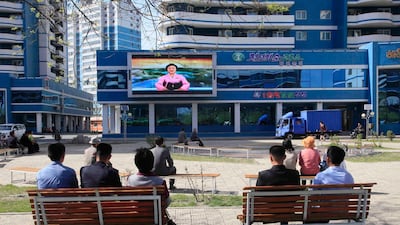 North Koreans in Pyongyang watch as their country's famous newsreader announces Kim Jong-un's proposal to suspend nuclear tests and long-range missile launches. Jon Chol / AP