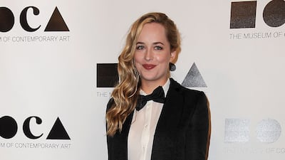 Dakota Johnson wore a tuxedo with a bow tie and chain to arrive at the 2011 Moca Gala in Los Angeles, California on November 12, 2011. AFP