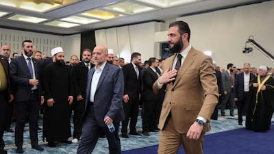 President Ahmad Al Shara, right, arrives for early morning prayers for Eid Al Fitr in Damascus, before revealing Syria's annual budget. Photo: Sana / AFP
