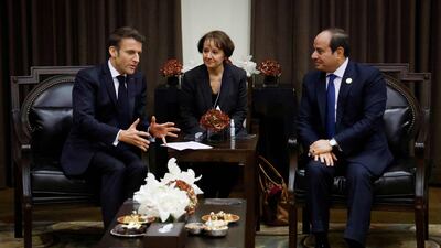 Mr Macron with Mr El Sisi on the sidelines of the conference. AFP
