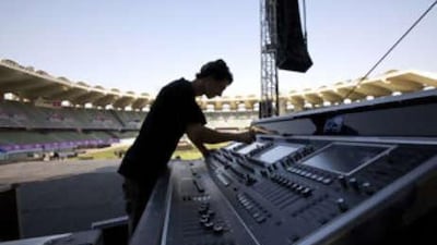 A technician sets up the equipment for the George Michael and Alicia Keys concert at the Zayed Sports Stadium in Abu Dhabi tonight.