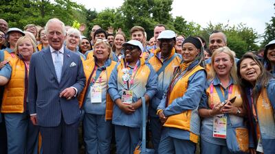 Prince Charles poses with Commonwealth Games volunteers during a visit to the Athletes' Village at the University of Birmingham. AP