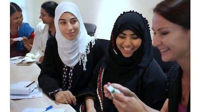 From left, Maria Abdeen, Amreen Ismail and Elena Mikhaylova participate in an exercise for focusing techniques at the Abu Dhabi workshop. Delores Johnson / The National