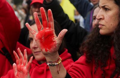 Protesters with red-painted hands demand the immediate return of Gaza hostages outside Israel's prime ministerial office in Jerusalem on Tuesday. Reuters