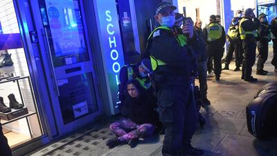 A woman is arrested by Police during a demo on Oxford Street on November 5, 2020 in London, England. Getty Image