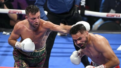 Jose Ramirez tries to evade a punch from Josh Taylor. AFP