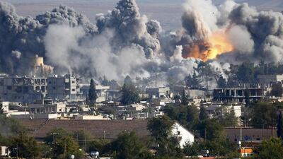 Smoke rises over Syrian town of Kobani after an airstrike, as seen from the Mursitpinar border crossing on the Turkish-Syrian border in the south-eastern town of Suruc in Sanliurfa province on Saturday. Kai Pfaffenbach / Reuters